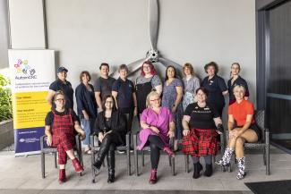 An image of Sylvia Rodger Academy alumni working group. A diverse group of people happily smile for a photo.